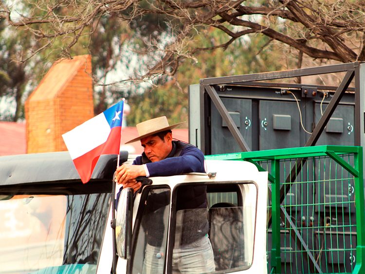 Persona decorando su camión con bandera chilena. Imagen propiedad de Francisca Miranda. Esta imagen está bajo licencia (CC BY-SA 4.0)